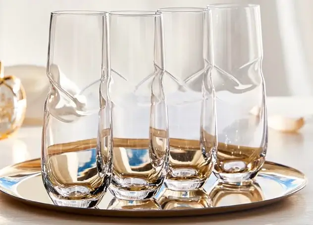 The Solstice Flute, a tall champagne flute with a golden hue.